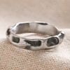 Men's Stainless Steel Molten Band Ring on Beige Coloured Fabric 
