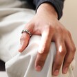 Model Wearing Men's Stainless Steel Molten Band Ring on His Thumb