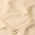 Crystal Edge Disc Pendant Necklace in Gold on Neutral Fabric