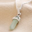Green Aventurine Crystal Point Pendant Necklace in Silver on Beige Fabric