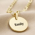 Close Up of Gold Disc Pendant With Blackened Engraving and Lora Font