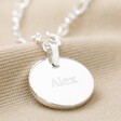 Close Up of Silver Disc Pendant With Clean Engraving and Lora Font