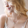 Blonde Model Wearing White Enamel Celestial Bee Pendant Necklace in Gold with White Top