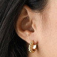 Close Up of Model Wearing Small Chunky Rope Huggie Hoop Earrings in Gold in Lobe