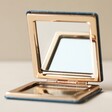 Open Metallic Blooming Lovely Compact Mirror on Flat Surface