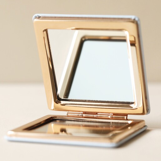 Open Paddleboarding Compact Mirror on Flat Surface