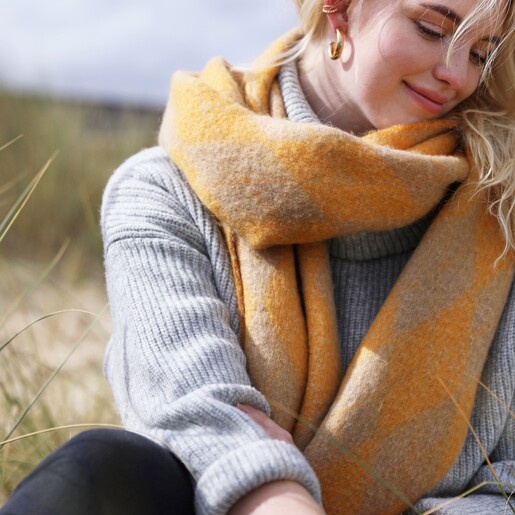 Model Wearing Mustard Harlequin Winter Scarf at Beach