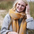 Smiling Blonde Model Wearing Mustard Harlequin Winter Scarf