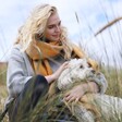 Mustard Harlequin Winter Scarf on Model Holding White Dog