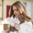 Model Holding Coffee Wears Neutral Striped Winter Scarf