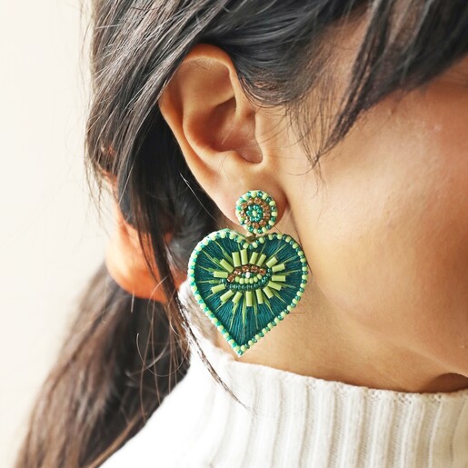 Close Up of Model Wearing My Doris Eye Love You Teal Beaded Heart Drop Earrings