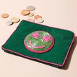 My Doris Green Smiley Coin Purse with Coins Spilling Out on Natural Background