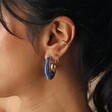 Blue Molten Resin Organic Hoop Earrings in Gold on Model Worn With Other Gold Earrings