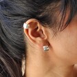 Close Up of Model Wearing Brushed Wide Huggie Hoop Earrings in Silver with Brushed Ear Cuff in Silver