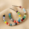 Colourful Small Beaded Hoop Earrings in Gold on Neutral Fabric