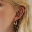 Close Up of Model Wearing Green Stone and Crystal Fern Drop Earrings in Gold