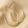 Hammered Teardrop Hoop Earrings in Gold on Beige Coloured Fabric