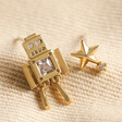 Mismatched Robot and Star Stud Earrings in Gold on Beige Fabric