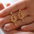 Model Holding Pink Stone and Crystal Fern Drop Earrings in Gold in Between Fingers