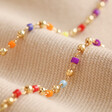 Close Up of Beads on Rainbow Beaded Feather Charm Necklace in Gold