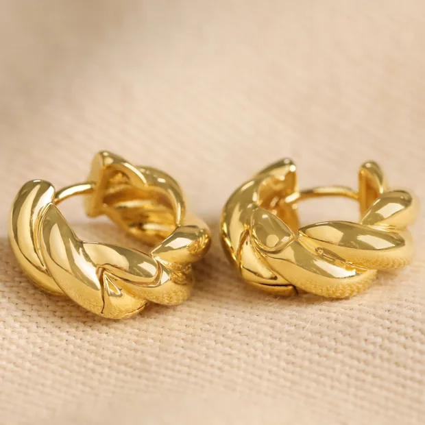 Rope Huggie Hoop Earrings in Gold Rope Huggie Hoop Earrings in Gold on Beige Fabric