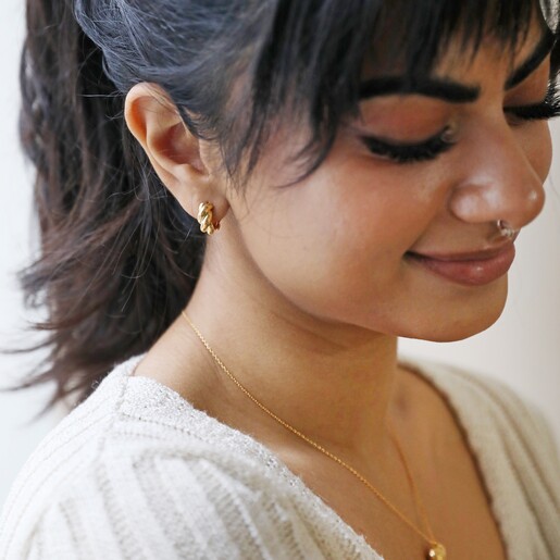 Rope Huggie Hoop Earrings in Gold on Smiling Model