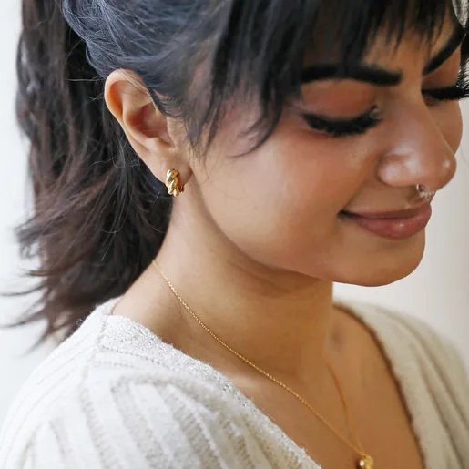 Rope Huggie Hoop Earrings in Gold on Smiling Model