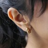 Close Up Shot of Model Wearing Rope Huggie Hoop Earrings in Gold