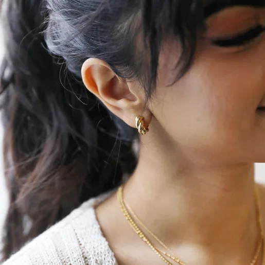 Close Up of Model Wearing Rope Huggie Hoop Earrings in Gold
