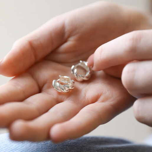 Rope Huggie Hoop Earrings in Silver Held in Hand