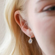 Close Up of Model Wearing Small Silver Flower and Crystal Drop Earrings