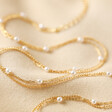 Tiny Seed Pearl Layered Chain Necklace in Gold on Beige Coloured Fabric 