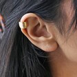 Close Up of Wide Brushed Ear Cuff in Gold on Model