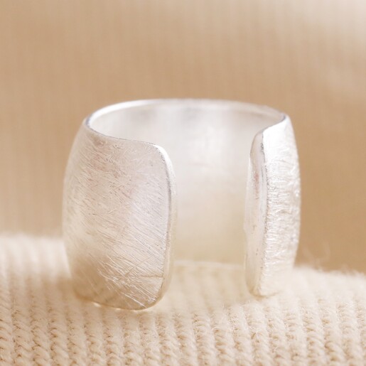 Back of Wide Brushed Ear Cuff in Silver on Natural Coloured Fabric