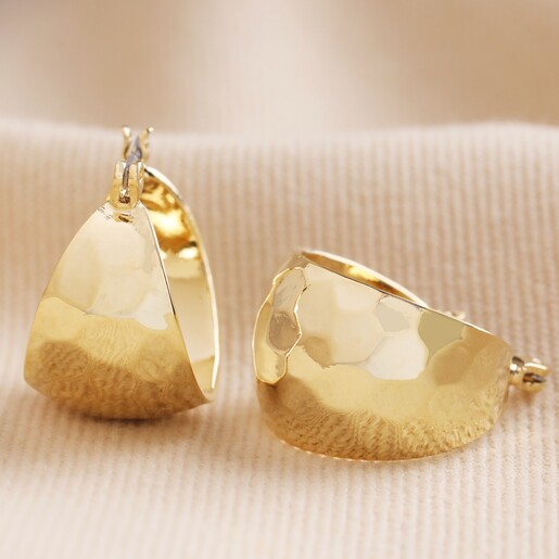 Wide Hammered Hoop Earrings in Gold on Neutral Fabric