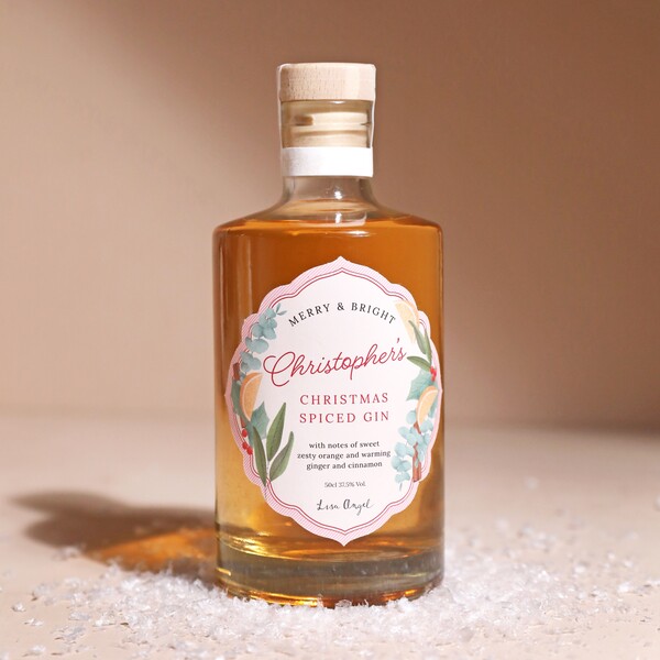 Personalised 500ml Christmas Spiced Gin on top of beige backdrop with fake snow