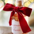 Personalised 500ml Family Christmas Spiced Gin on wooden counter with bow in shot 