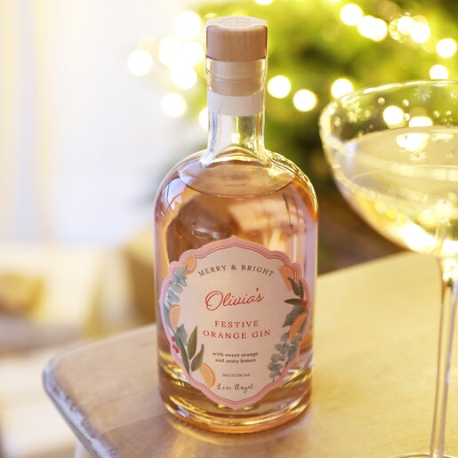 Personalised 500ml Festive Orange Gin in lifestyle shot on top of counter with glass in foreground