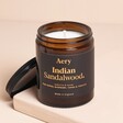 Aery Pepper Raspberry Tonka Indian Sandalwood Scented Jar Candle with an open lid on a neutral background