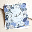 Amazing Mum Blue Floral Christmas Card on top of envelope with beige surface behind