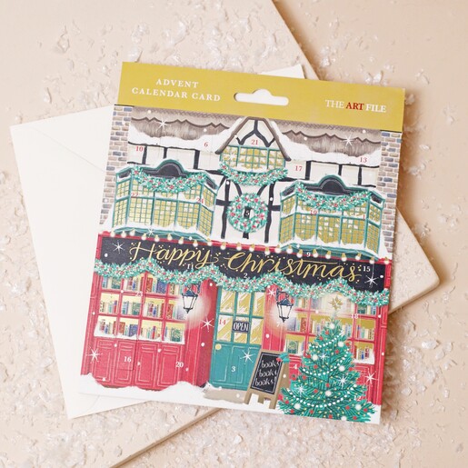 St Nicolas Street Advent Christmas Card lying on top of envelope on pink surface