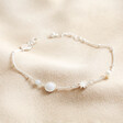 Pearl and Crystal Moon and Stars Bracelet in Silver on Beige Fabric