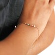 Colourful Gemstone Bar Bracelet in Gold close in on model's wrist