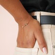 Colourful Gemstone Bar Bracelet in Gold close in on model's wrist in back pocket