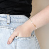 Model Wearing Pearl and Crystal Moon and Stars Bracelet in Gold With Hand in Pocket