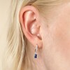 Close Up of Blue Stone and Crystal Charm Huggie Hoop Earrings in Silver on Model