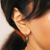 Close Up of Model Wearing Crystal Spike Huggie Hoop Earrings in Gold