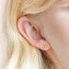 Close Up of Model Wearing Delicate Bird Stud Earrings in Gold