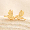 Delicate Bird Stud Earrings in Gold on Beige Fabric