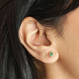 Close up of Green Crystal Stud Earrings in Gold on model